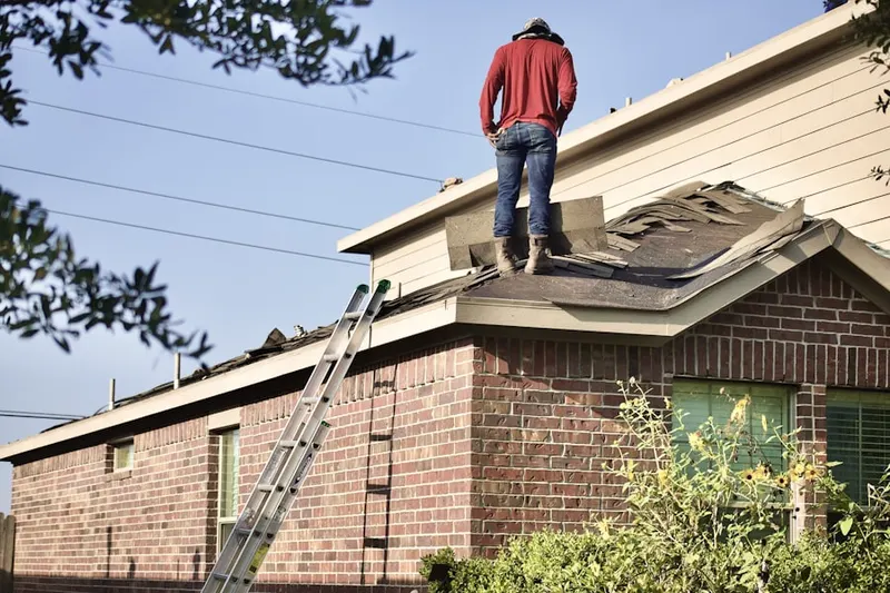 Professional roofer working on a residential roof in Bel Aire
